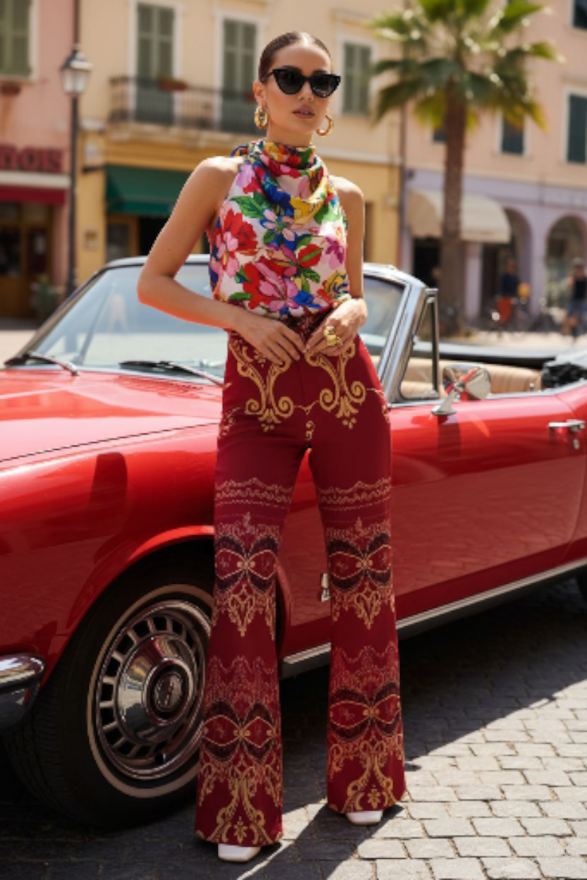Woman wearing burgundy high waist wide leg pants with intricate gold patterns by Angelic Blessings Shop