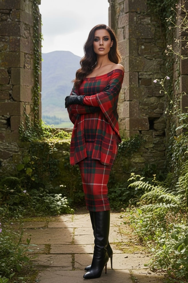 Woman wearing Clan Fraser tartan off shoulder dress with black boots standing in stone archway