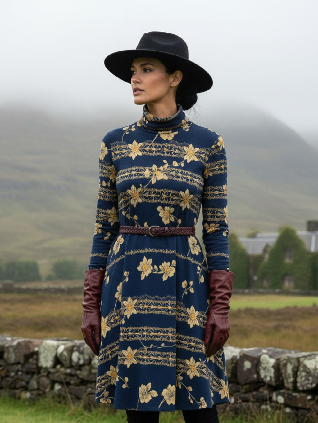 Navy blue floral high neck dress with long sleeves worn with black hat and brown gloves outdoors