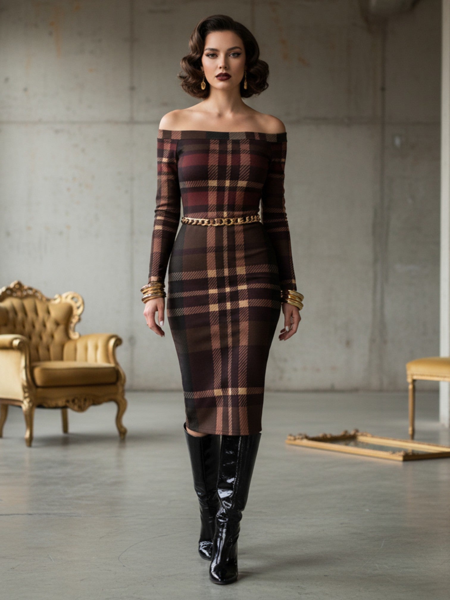 Woman wearing a tartan off the shoulder midi dress with long sleeves and a gold chain belt