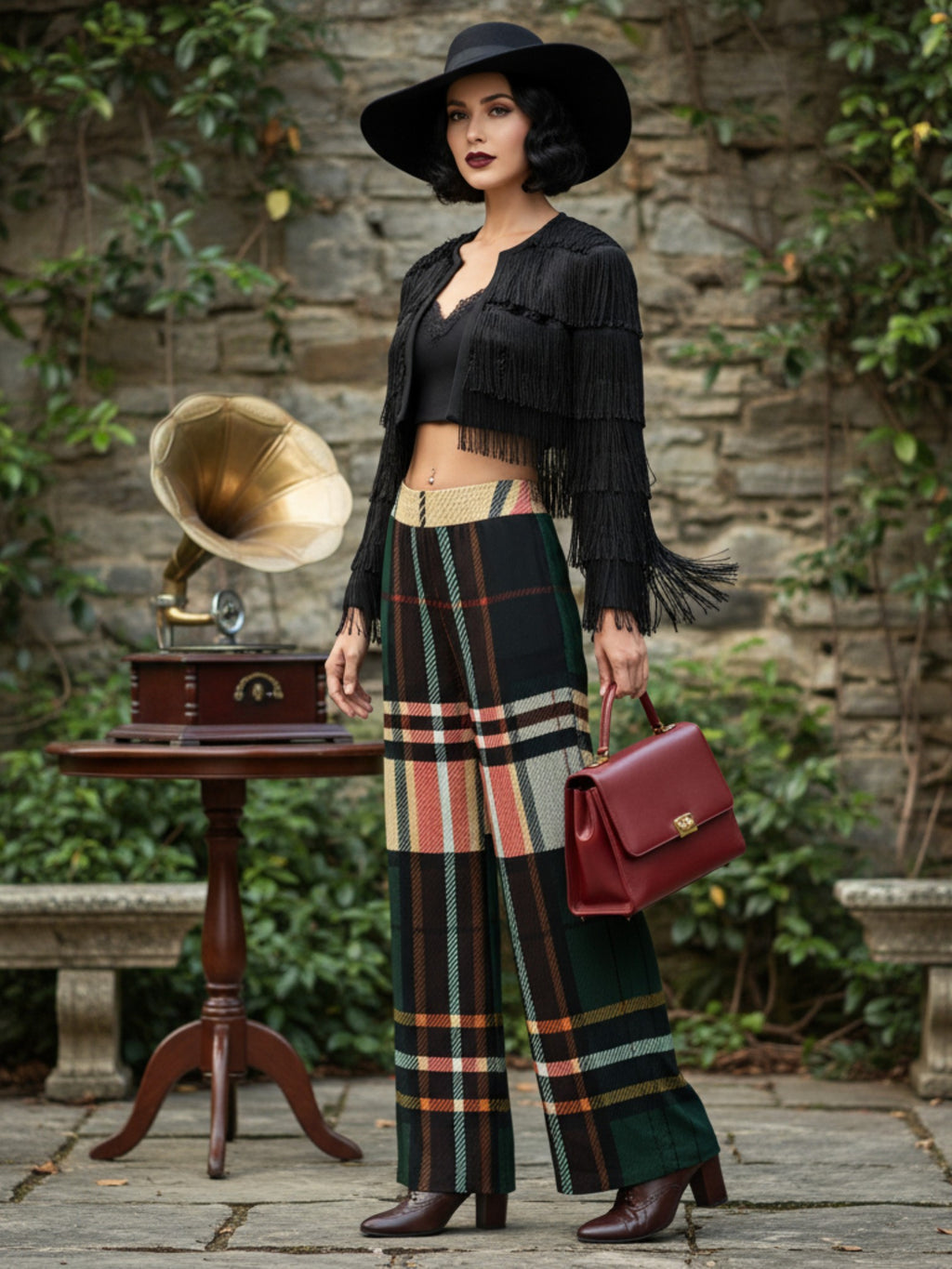 Woman wearing women's tartan wide-leg trousers in green and beige plaid with black fringe jacket and hat