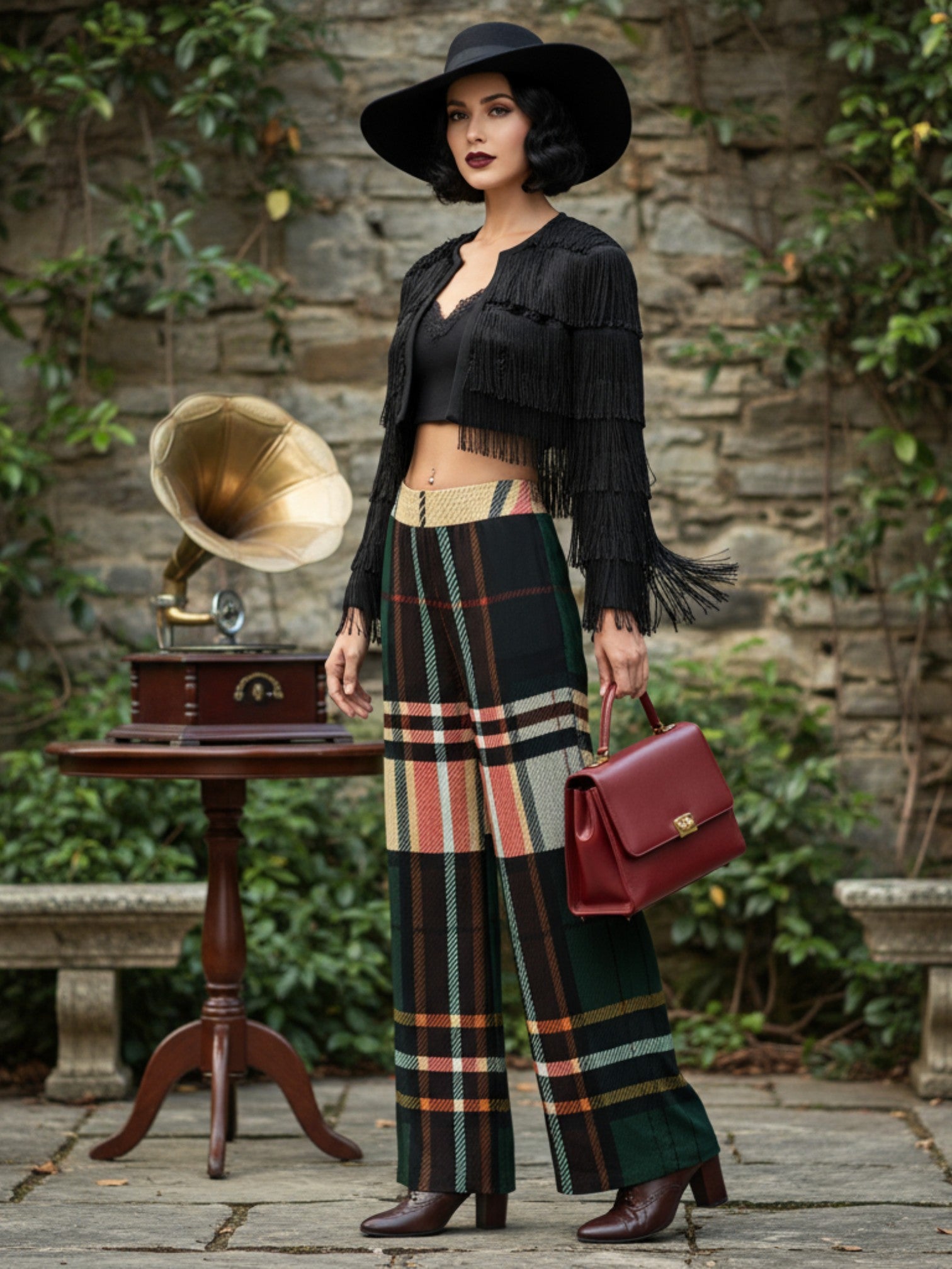 Woman wearing women's tartan wide-leg trousers in green and beige plaid with black fringe jacket and hat