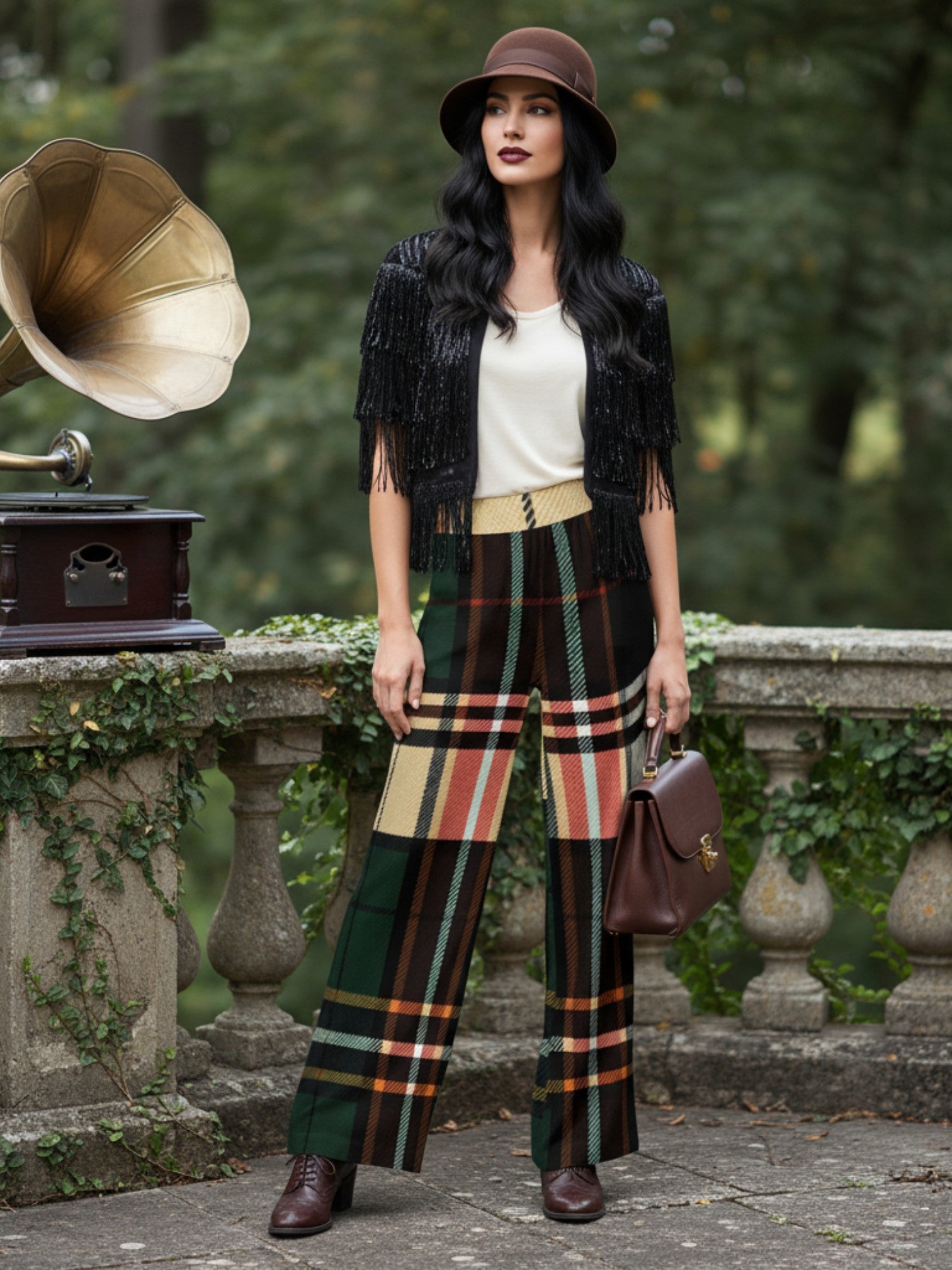 Woman wearing women's tartan wide-leg trousers in green and orange plaid with black fringe jacket